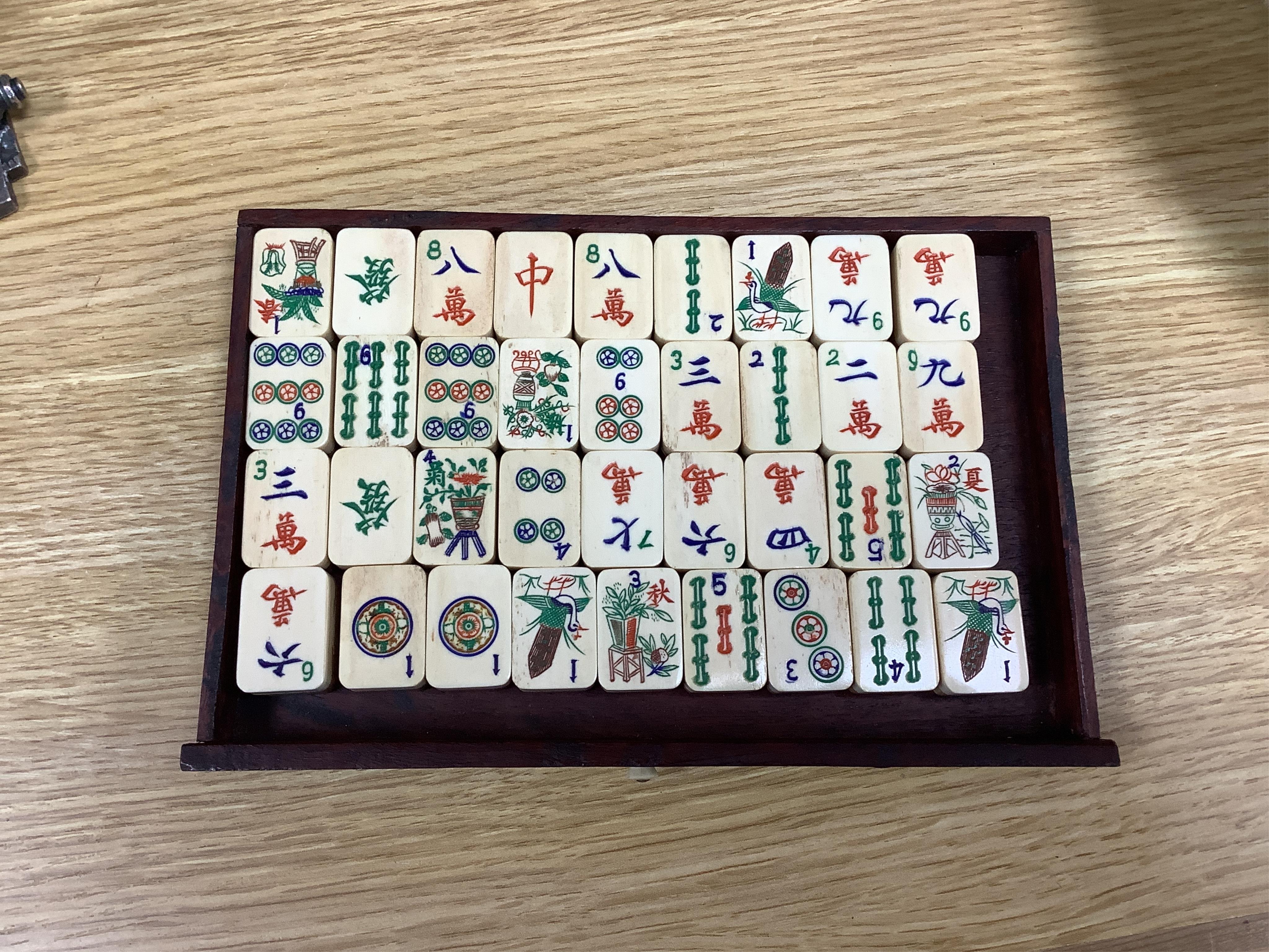 An early 20th century Chinese Mah Jong set, with bone tiles, 22cm x 15.5cm x 14.5cm. Condition - fair, one drawer front replaced